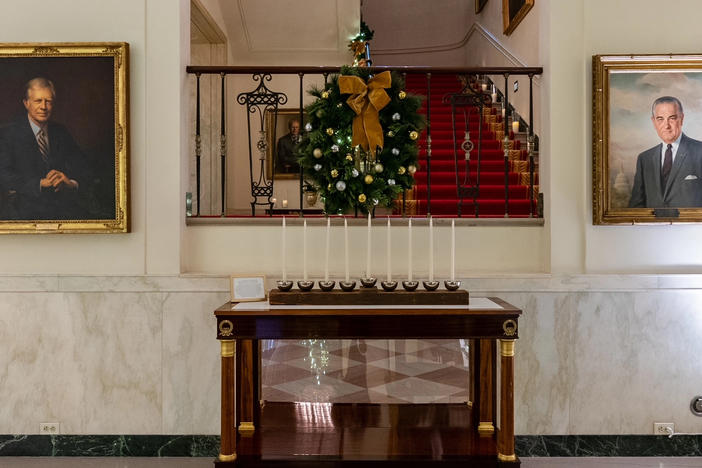 The White House Menorah can be seen in Cross Hall and is part of this year's "We The People"-themed holiday display. The Bidens will add the menorah to the permanent White House collection at a Hanukkah reception Monday evening,