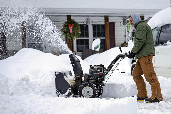 A man clears a driveway after a snow storm passed through northern Minnesota last week. Forecasters say another big storm is expected to hit the region this week.