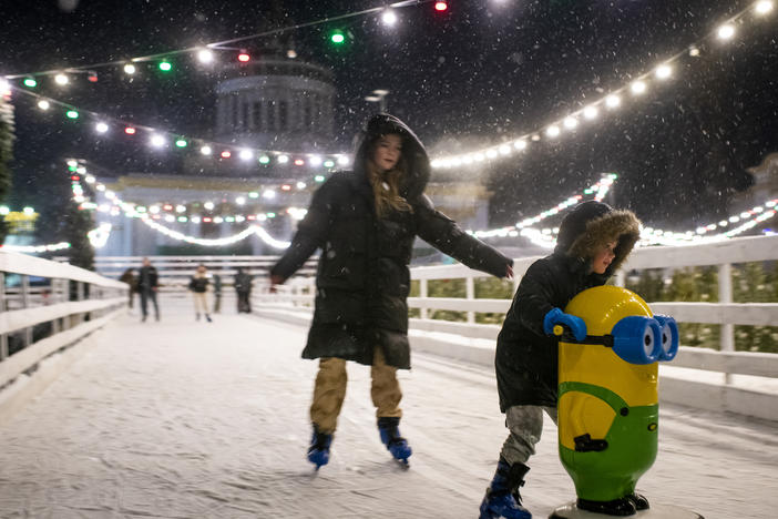 People ice skate at a Christmas market at VDNG, the Expocenter of Ukraine, in Kyiv on Dec. 3.