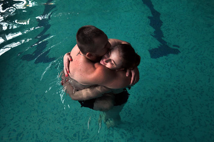 Sgt. Mykhailo (Misha) Varvarych, 28, and his fiance, Iryna (Ira) Botvynska, 19, take part in a therapeutic swimming activity at Moldova pool in Truskavets, Ukraine.