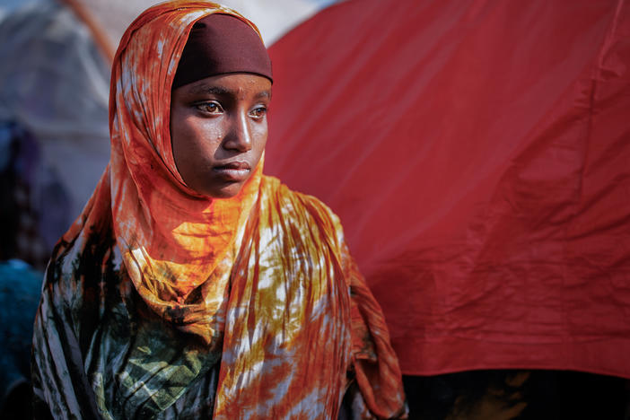 A girl poses for a portrait in a camp for internally displaced people on the outskirts of Baidoa, Somalia, on Dec. 14. As people flee their homes because of drought, famine and fighting, camps have sprung up this year around the Somali capital and other cities.
