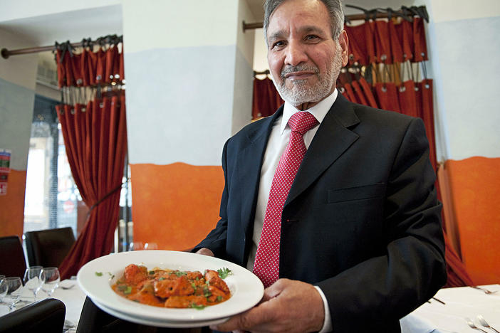Ahmed Aslam Ali, the owner of the Shish Mahal restaurant in Glasgow, Scotland, is pictured with a plate of chicken tikka masala in his restaurant, on July 29, 2009.
