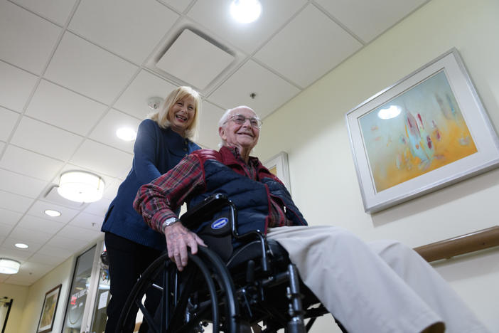 Paula Naylor pushes her father, Paul Romanello, with his wheelchair on Dec. 21 in Tulsa, Okla. Romanello was recently celebrated by the Centenarians of Oklahoma when he turned 100 years old.