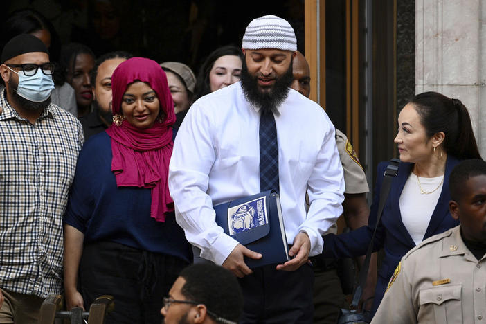 Adnan Syed (center right) leaves the courthouse after a hearing on Sept. 19, 2022, in Baltimore. Syed, who was released from a Maryland prison this year after his case was the focus of the true-crime podcast "Serial," has been hired by Georgetown University as a program associate for its Prisons and Justice Initiative.