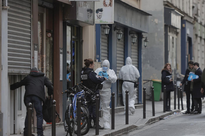 Police in Paris investigate at the scene of a shooting on Friday that left three people dead and three others wounded. A 69-year-old suspect was wounded and arrested.