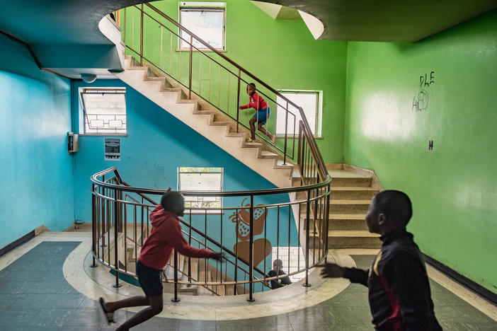 Boys play in a stairwell in Cissie Gool House, an abandoned hospital now home to over 1,000 people. By painting, decorating and maintaining the building, its new residents have managed to turn it into a decent home for themselves and their families within striking distance of central Cape Town.