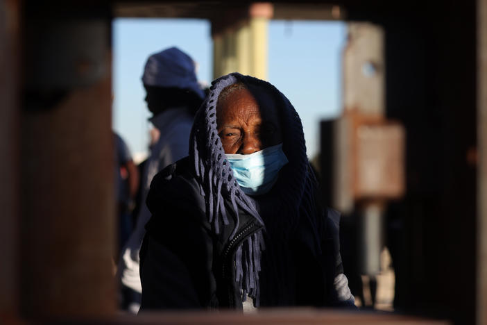 An asylum-seeking migrant from Nicaragua bundles up at the border as she waits to be processed by U.S. Customs and Border Protection after crossing the Rio Grande River into the United States in El Paso, Texas, U.S., December 22, 2022.