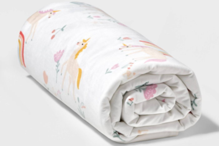 The children's Pillowfort weighted blanket is shown in unicorn pink. The item and its variations is being recalled at Target stores after two girls died from asphyxiation after becoming trapped under one.