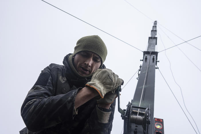 Ukrainian servicemen from 127 brigade prepare a telescopic tower with a remote camera installed on a Soviet car "Volga" that was recast to observe and correct fire on the front line near Kharkiv, Ukraine, on Sunday.