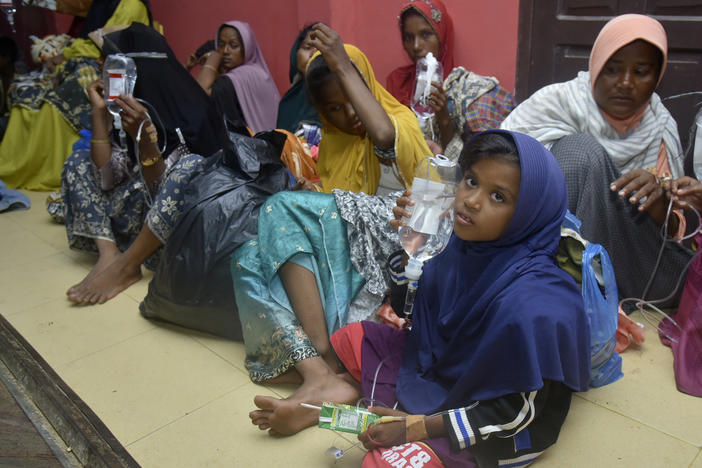 Ethnic Rohingya women and children sit on the floor upon arrival at a temporary shelter after their boat landed in Pidie, Aceh province, Indonesia, Monday, Dec. 26, 2022. A second group in two days of weak and exhausted Rohingya Muslims landed on a beach in Indonesia's northernmost province of Aceh on Monday after weeks at sea, officials said.