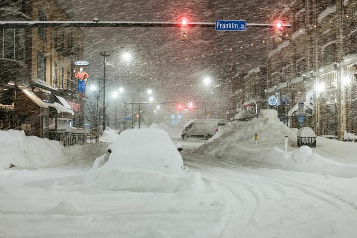 Vehicles are seen abandoned in heavy snowfall in downtown Buffalo, New York, on Monday. Emergency crews counted the grim costs of a colossal winter storm that brought Christmas chaos to the U.S., especially in hard-hit western New York.