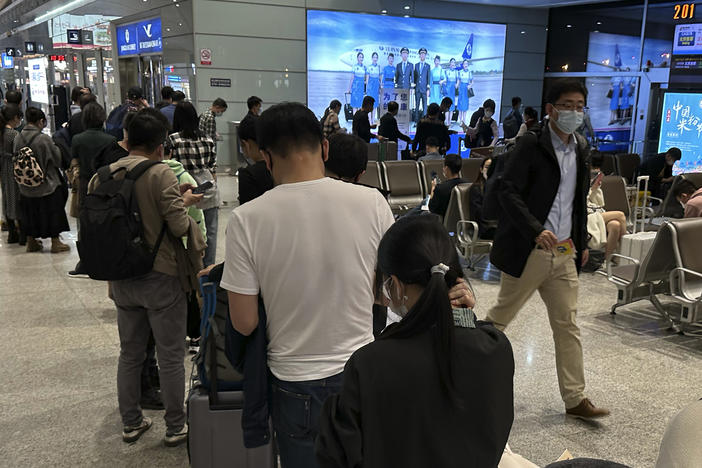 Passengers prepare to board a flight at the airport in north-central China's Jiangxi province on Nov. 1, 2022.