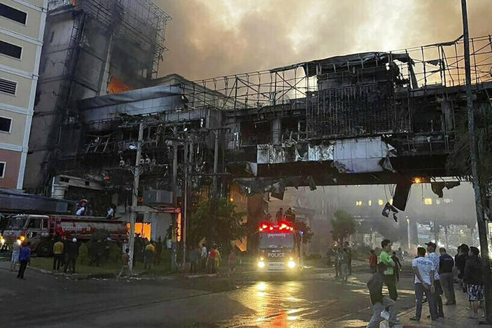 In this photo provided by Cambodia's Fresh News, smoke rises as a fire burns Thursday through the Grand Diamond City Casino and Hotel near a Cambodia-Thai international border gate in Poipet, Cambodia.