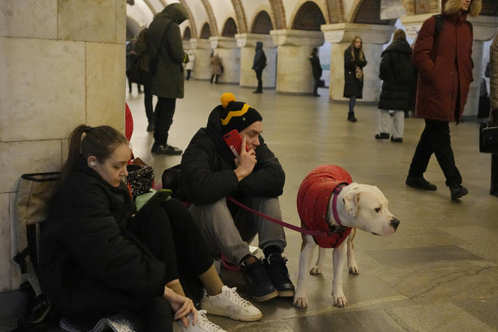 People rest in the subway station being used as a bomb shelter during a rocket attack in Kyiv, Ukraine, Thursday.