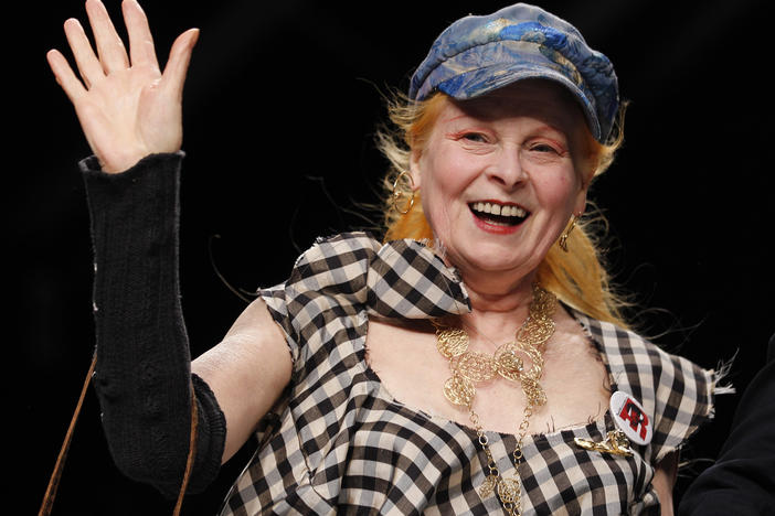 British fashion designer Vivienne Westwood waves to the audience after presenting her fashion collection at Milan Fashion Week in 2012. Westwood, an influential fashion maverick who played a key role in the punk movement, died Thursday at 81.