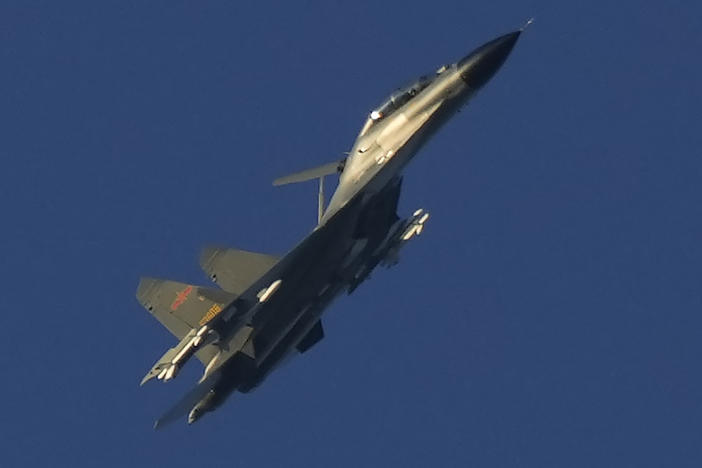 A Chinese J-11 military fighter jet flies above the Taiwan Strait near Pingtan, the closest land of mainland China to the island of Taiwan, in southeastern China's Fujian Province on Aug. 5, 2022.