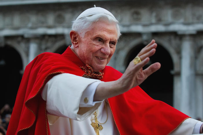 Pope Benedict XVI greets the crowd gathered in St Mark's Square while crossing the square on an electric car in 2011 in Venice, Italy.