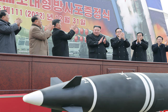 In this photo provided by the North Korean government, North Korean leader Kim Jong Un, center, attends a ceremony of donating 600 mm super-large multiple launch rocket system at a garden of the Workers' Party of Korea headquarters in Pyongyang, North Korea, on Saturday, Dec. 31, 2022.