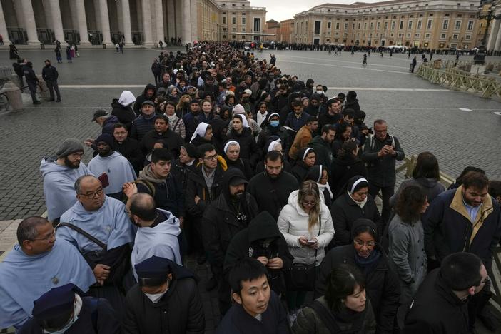 People wait in a line to enter Saint Peter's Basilica at the Vatican where late pope Benedict 16 is being laid in state at The Vatican, Monday, Jan. 2, 2023.