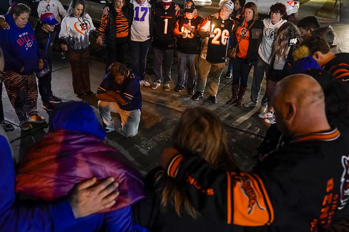 Fans gather outside University of Cincinnati Medical Center, late Monday in Cincinnati, where the Buffalo Bills' Damar Hamlin was taken after collapsing on the field during an NFL football game against the Cincinnati Bengals.