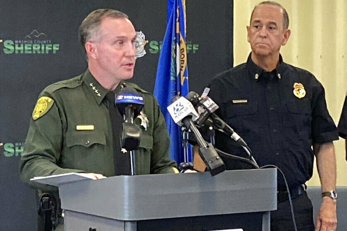 Washoe County Sheriff Darin Balaam, left, answers a reporter's question as fire officials look on Tuesday during a news conference in Reno, Nev., about the accident that seriously injured actor Jeremy Renner on a private mountain road near Lake Tahoe on New Year's Day.