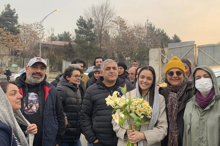 Prominent Iranian actress Taraneh Alidoosti (center) holds flowers as she poses for a photo among her friends after being released from Evin prison in Tehran, Iran, on Wednesday.