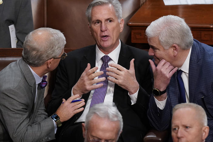Rep. Kevin McCarthy, R-Calif., is flanked by Rep. Patrick McHenry, R-N.C., left, and Rep. Tom Emmer, R-Minn., right, in the House chamber as lawmakers meet for a second day to elect a speaker and convene the 118th Congress.