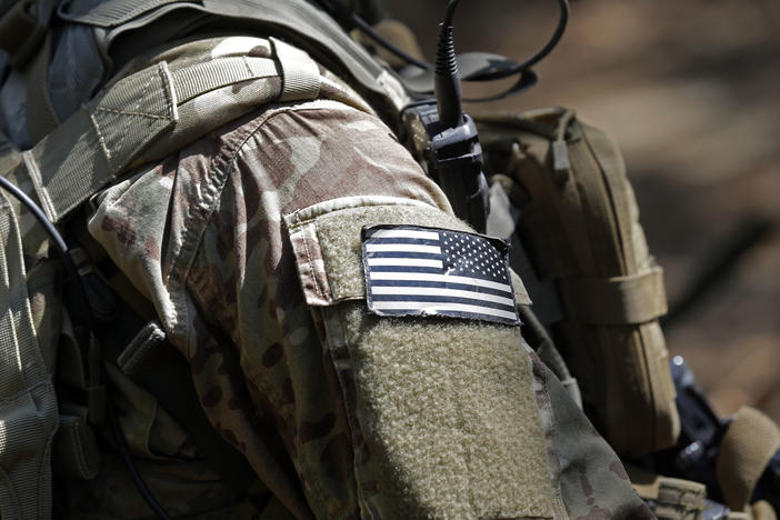 In this photo taken Friday, April 21, 2017 a United States flag patch adorns the uniform of a paratrooper with the 82nd Airborne Division's 3rd Brigade Combat Team during a training exercise at Fort Bragg, N.C.