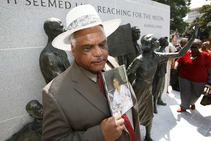 Roderick Johns holds a photo of his sister Barbara Johns at the newly dedicated Virginia Civil Rights Memorial on the grounds of the State Capitol in Richmond, Va. in July 2008.