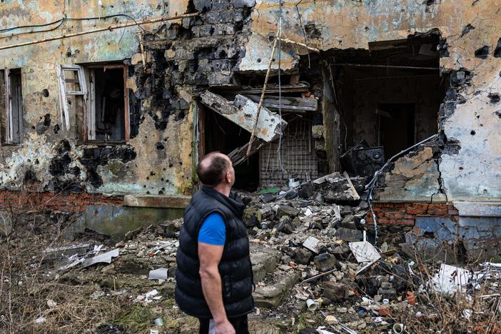 Andryi Pleshan checks destruction around his shelter in the city of Izium in eastern Ukraine on Jan. 2.