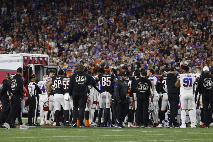 Players look on Monday as Damar Hamlin of the Buffalo Bills is treated by medical personnel at Paycor Stadium in Cincinnati, Ohio.