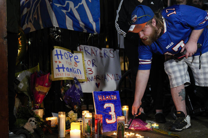 Buffalo Bills fan Dustin Peters attends a candlelight vigil for Bills safety Damar Hamlin at the University of Cincinnati Medical Center on Tuesday.