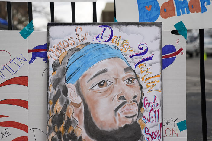 An artist's portrait of Buffalo Bills safety Damar Hamlin is displayed Thursday outside UC Medical Center, where the 24-year-old remains hospitalized.