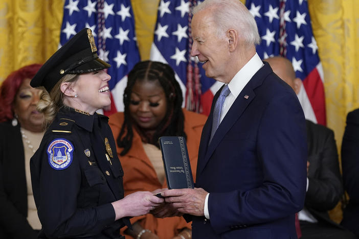 President Biden awards the Presidential Citizens Medal, the nation's second-highest civilian honor, to U.S. Capitol Police officer Caroline Edwards during a ceremony to mark the second anniversary of the Jan. 6 assault on the Capitol in the East Room of the White House on Friday.