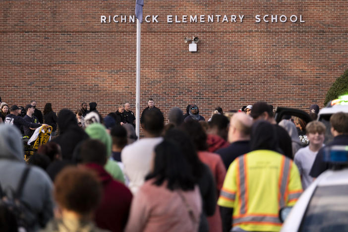 Students and police gather outside of Richneck Elementary School after a shooting on Friday, Jan. 6, in Newport News, Va. A shooting at a Virginia elementary school sent a teacher to the hospital and ended with "an individual" in custody Friday, police and school officials in the city of Newport News said.