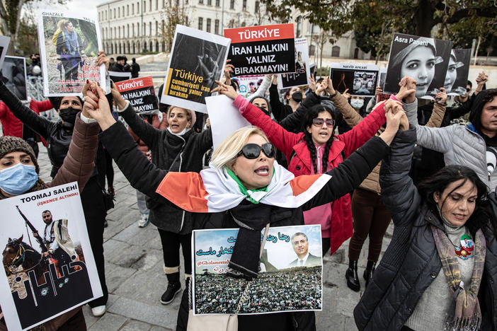 Protesters hold placards with messages such as "Do not leave the people of Iran alone" during a demonstration on Dec. 3 in Istanbul.