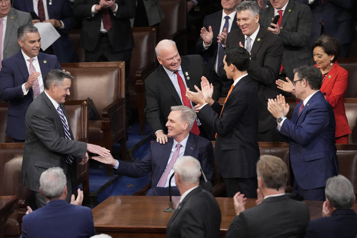Rep. Kevin McCarthy, R-Calif., is congratulated after winning the 15th vote in the House chamber as the House enters the fifth day trying to elect a speaker and convene the 118th Congress in Washington, early Saturday.
