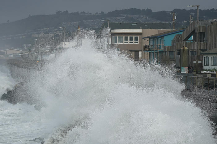 Waves crash into a seawall in Pacifica, Calif., Friday, Jan. 6, 2023. California weather calmed Friday but the lull was expected to be brief as more Pacific storms lined up to blast into the state, where successive powerful weather systems have knocked out power to thousands, battered the coastline, flooded streets, toppled trees and caused at least six deaths.