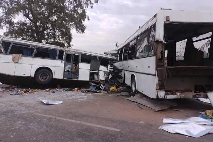 Two damaged buses are pictured after they collided on a road in Gniby, Senegal, on Sunday. At least 40 people were killed and dozens injured in crash.
