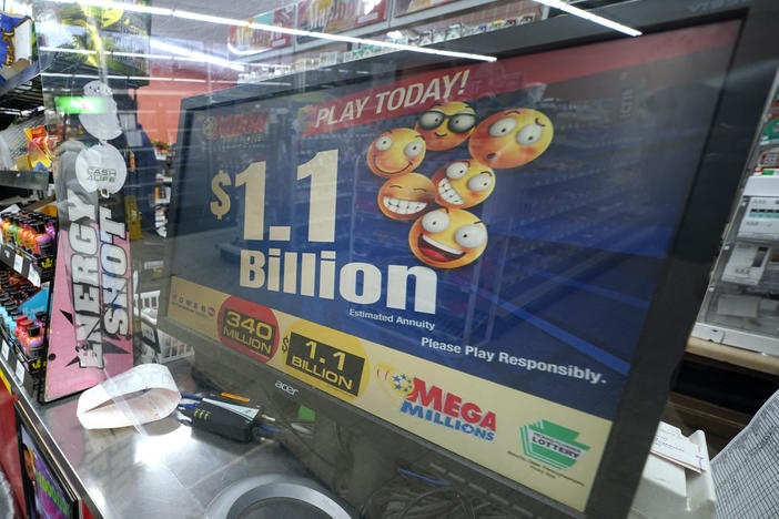 A Mega Millions customer purchases her tickets for the estimated jackpot of $1.1 Billion at the Fuel On Convenience Store in Pittsburgh, Monday, Jan. 9, 2023. Twenty-four consecutive drawings later with no grand prize winner named, the Mega Millions jackpot is now over $1 billion, making it one of the largest jackpots in lottery history. The next drawing is Friday.