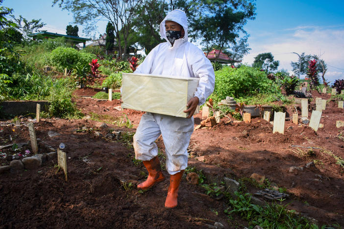 A gravedigger prepares to bury the coffin of a baby who died of COVID-19, at a cemetery in Bandung, Indonesia. Rates of childhood mortality are notably high in South Asia and sub-Saharan Africa, but it is a worldwide concern.