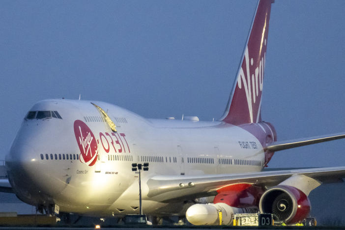 Cosmic Girl, a Boeing 747 modified to carry the LauncherOne rocket under its left wing, took off from the new Cornwall Spaceport in Newquay, U.K., Monday night. The craft is seen here hours before taking off.