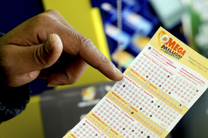 A Mega Millions lottery slip is displayed at Lucky Mart in Chicago on Tuesday, Jan. 10, 2023. After nearly three months of lottery losing, the Mega Millions jackpot has swelled above $1 billion. The odds of winning the top lottery prize are formidable at 1 in 302.6 million.