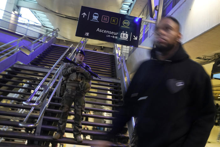 A soldier patrols at the Gare du Nord train station on Wednesday after an attacker stabbed 6 people before being shot by police.