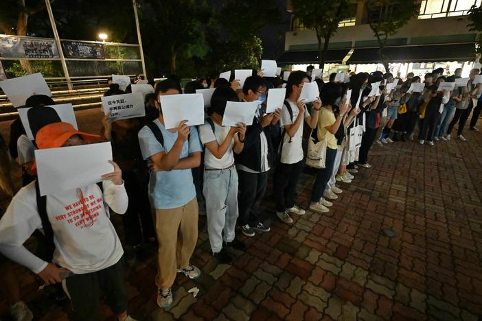 Students hold up placards including blank white sheets of paper on the campus of the Chinese University of Hong Kong, in solidarity with protests held on the mainland over Beijing's COVID-19 restrictions, on Nov. 28.