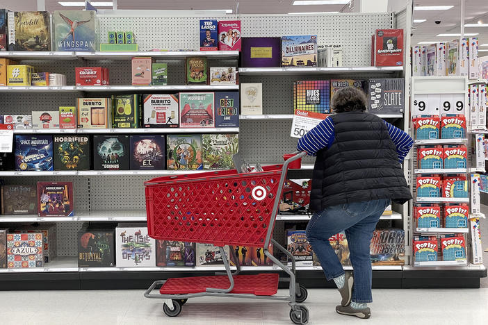 A Target customer looks at a display of board games while shopping at Target store in San Francisco, Calif. Inflation continues to ease, even if many people many not feel that way in their daily lives.