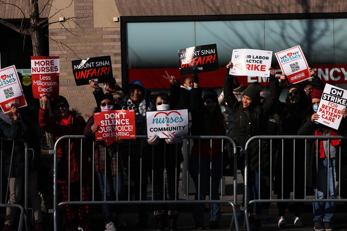 Nurses hold signs outside Manhattan's Mount Sinai Hospital on Monday, the first day of their strike.