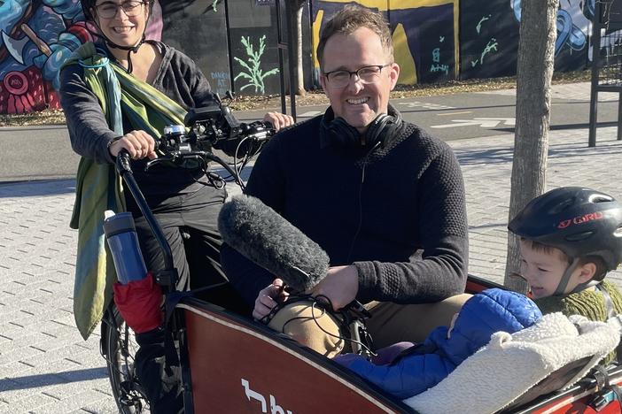 Lelac Almagor and two of her children take NPR's Adam Bearne for a ride in their e-cargo bike.