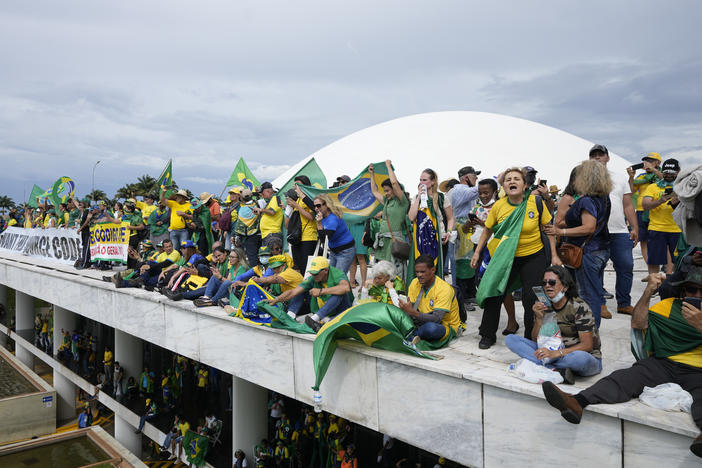 Protesters, supporters of Brazil's former President Jair Bolsonaro, stand on the roof of the National Congress building after they stormed it, in Brasília, Brazil, on Sunday.