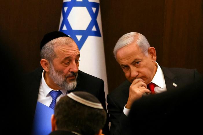 Israel's Prime Minister Benjamin Netanyahu (right) sits next to Interior and Health Minister Aryeh Deri during a weekly cabinet meeting on Jan. 8, 2023.